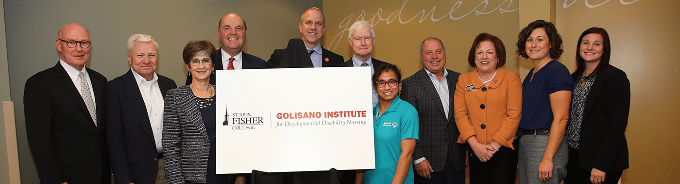Golisano trustees and St. John Fisher University staff posing with a sign