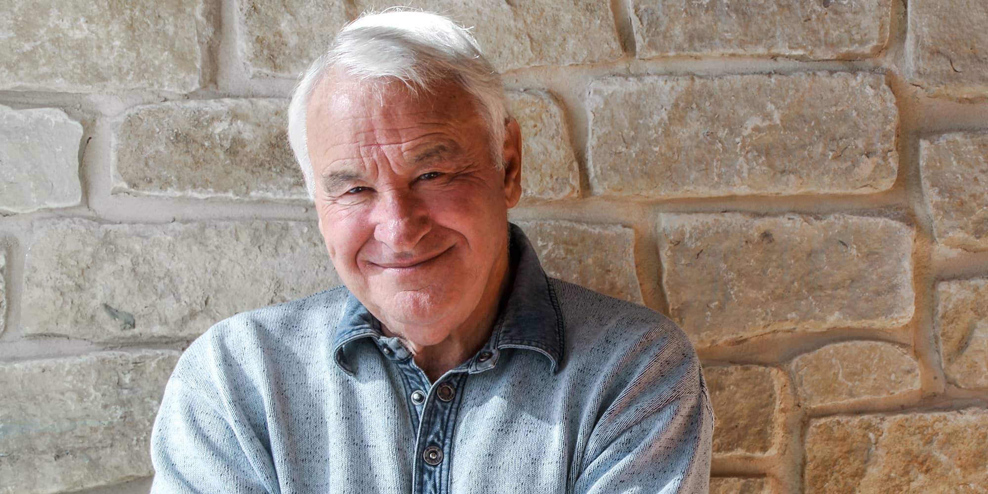 Tom Golisano with arms crossed.