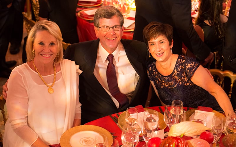 Three people at a table looking up for the camera