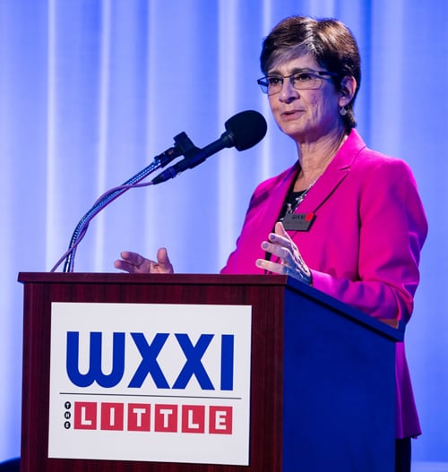 Ann Costello Accepts WXXI Associates Award at a podium