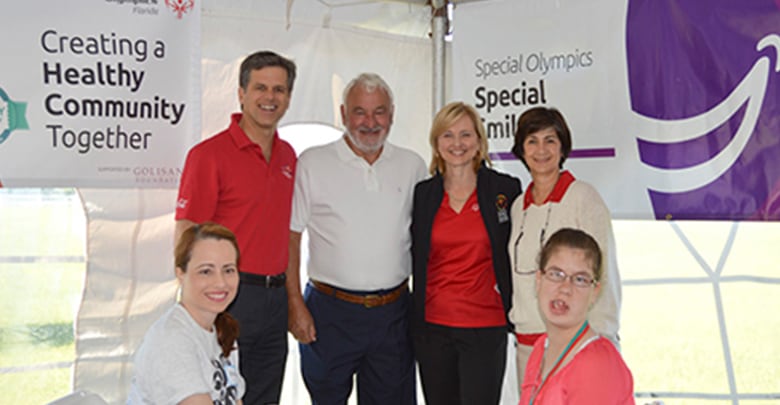Tim Shriver, Tom Golisano, Ann Costello, and others pose for a photo at the Special Olympics Annual State Equestrian Championship in Florida.