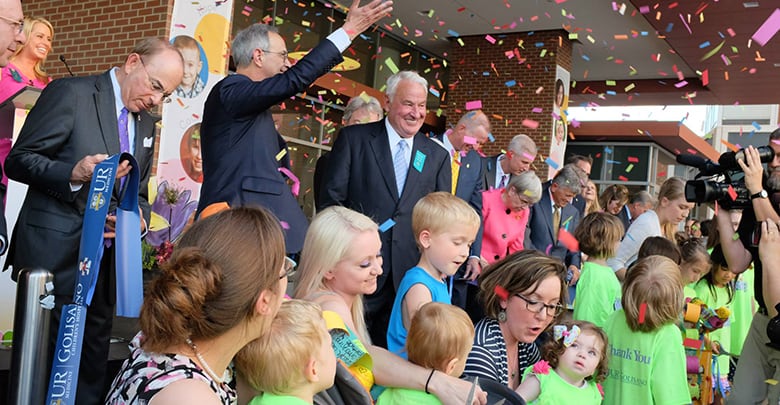 Tom Golisano and a large group celebrate the ribbon cutting at the Golisano Children's Hospital in Rochester, NY.