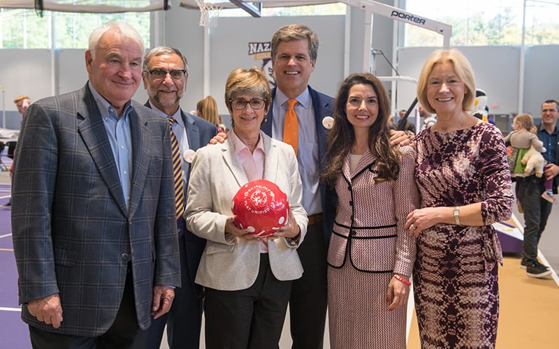 Tom Golisano, Tim Schriver, Ann Costello, and other pose for a phot at the Golisano Training Center at Nazareth College