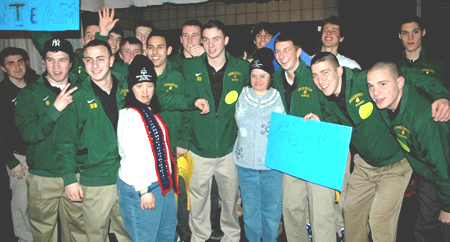 Group of people posing for a photo at the Special Olympics Winter Games.