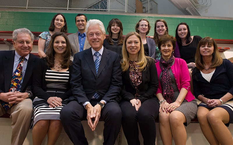 President and Chelsea Clinton posing with a group from the Golisano Foundation