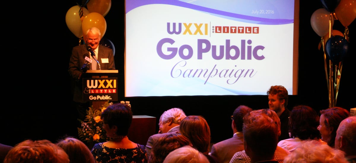 Tom Golisano giving a speech at a podium at a WXXI Golisano grant event