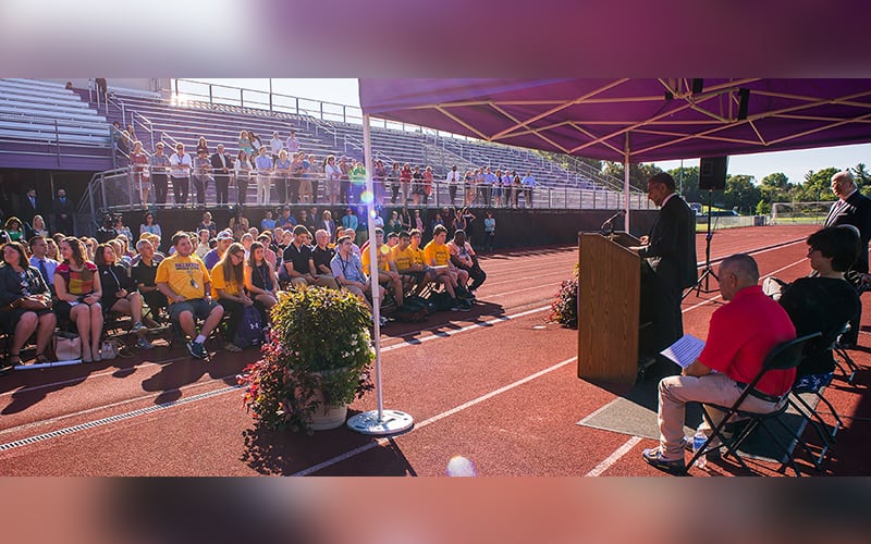 Speech being given on athletic track at Nazareth College