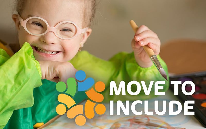 Little girl with glasses painting a picture with the Move to Include logo
