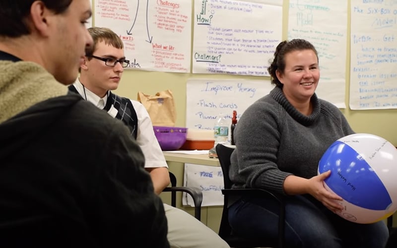 Students at Roberts Weselyan University's BELL program. One student holds a beach ball.