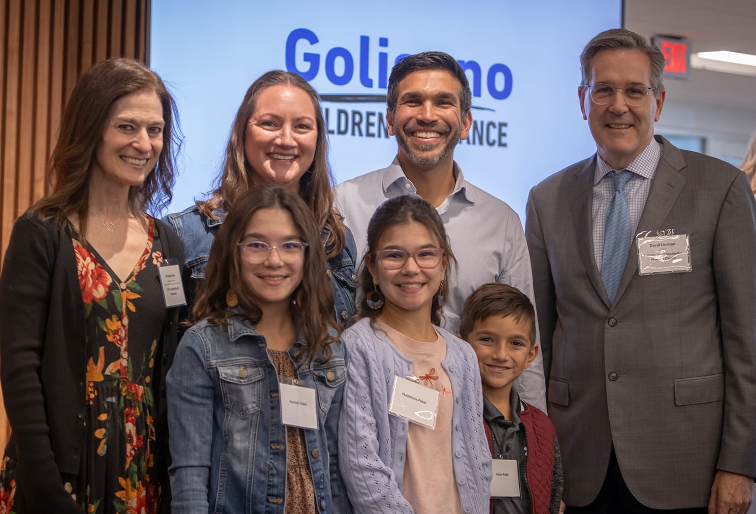 A family with three young children poses for a photograph.